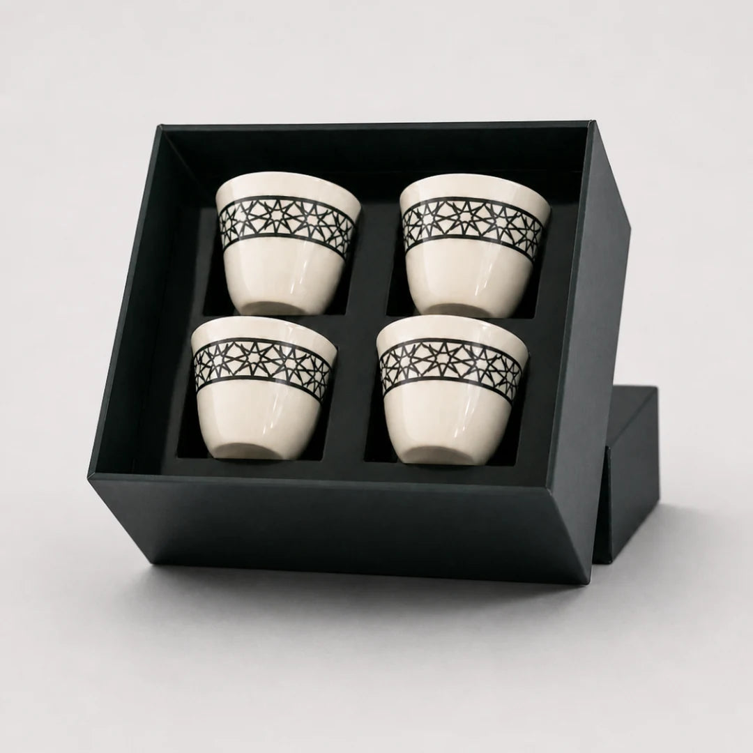 Four decorative ceramic cups in a black rigid presentation box
