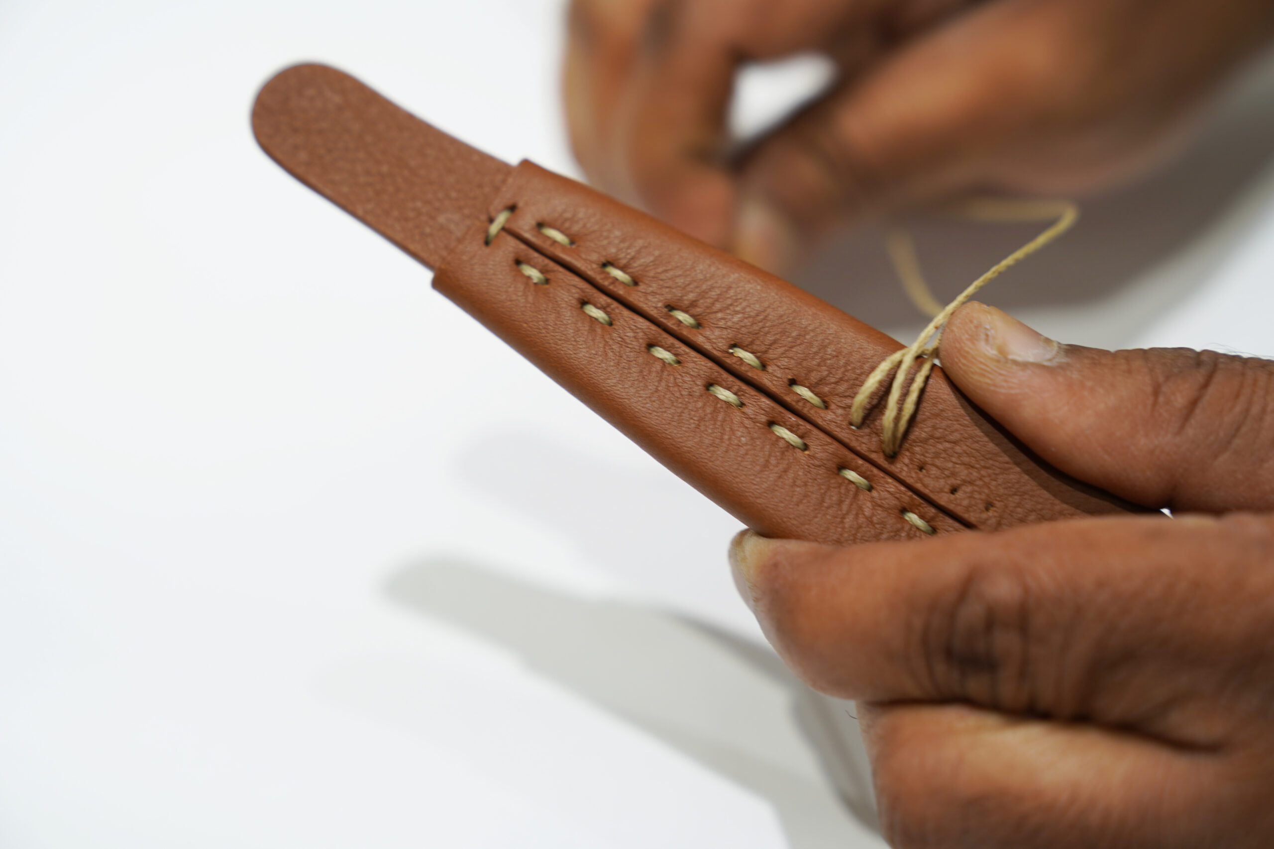 Hand stitching leather by The Box Artisans